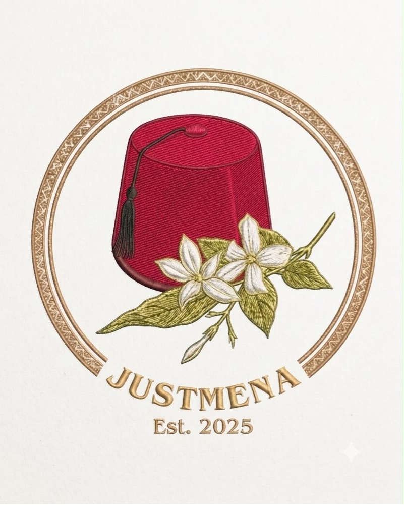 JustMENA-loggan: en broderad röd fez med jasminblommor i en gyllene ring, Est. 2025